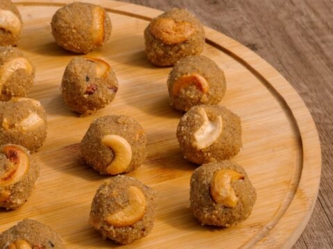 Round laddus on a wooden board