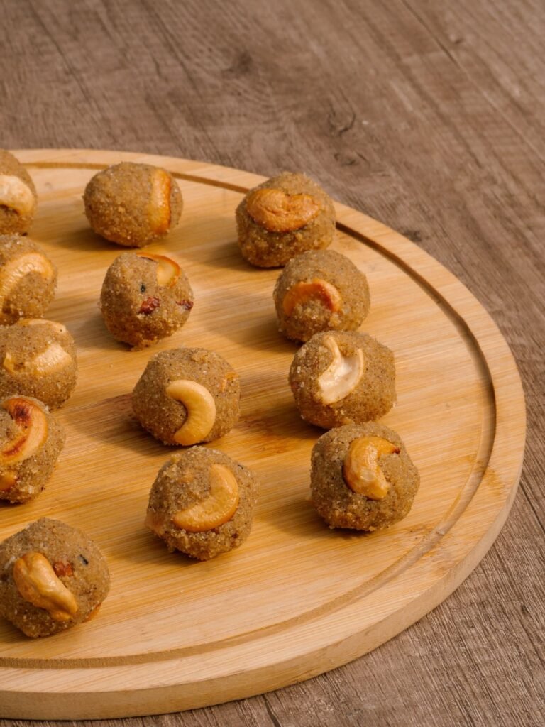 Round laddus on a wooden board
