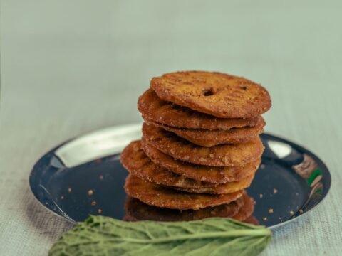 A stack of crisp thattai on a plate