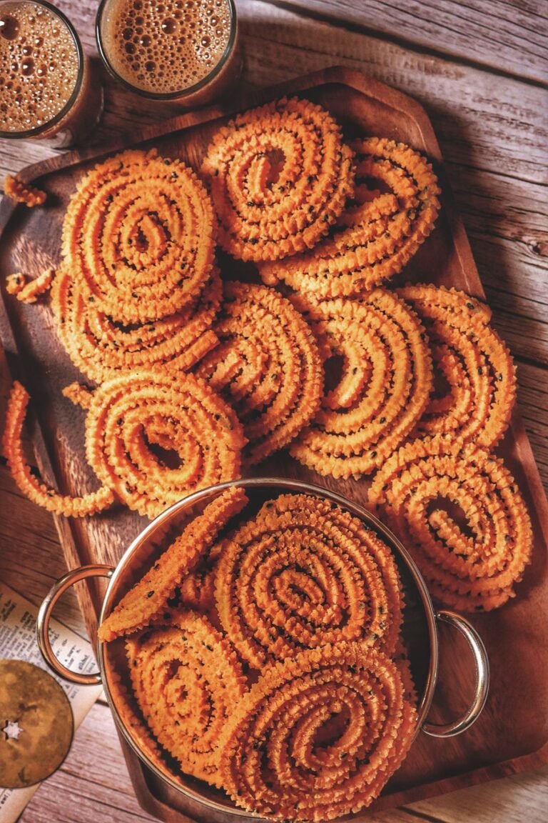 Crispy murukku spirals on a wooden board